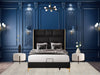 Luxurious bedroom with a large black headboard luxury bed and ornate blue walls.